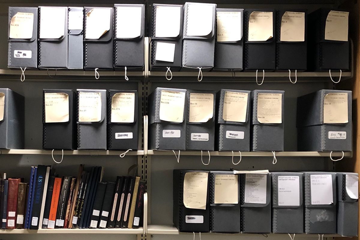 Library shelves featuring grey archival boxes