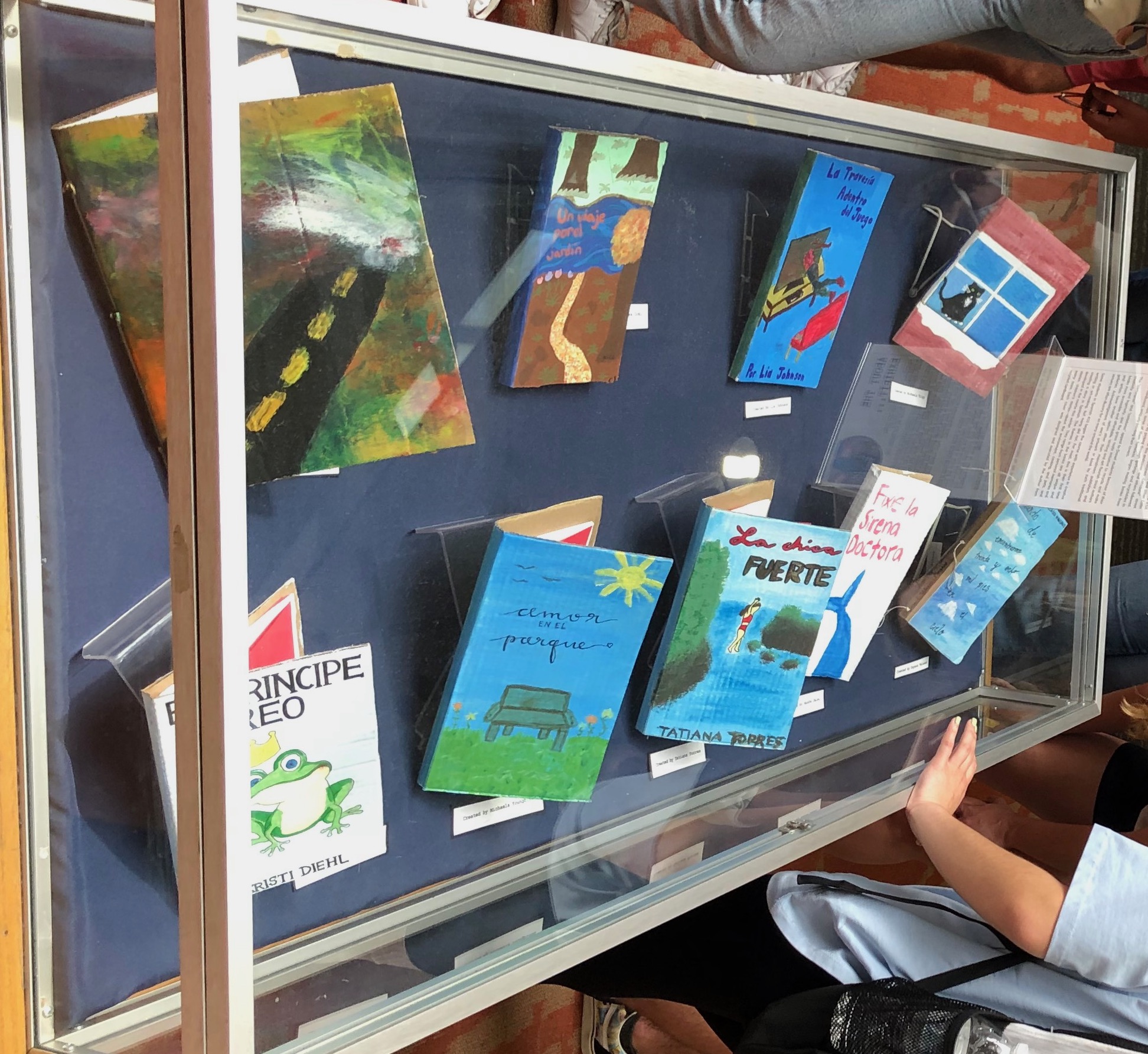 close-up of painted cardboard books on display in Hagerty Library for the Drexel Cartonera exhibition