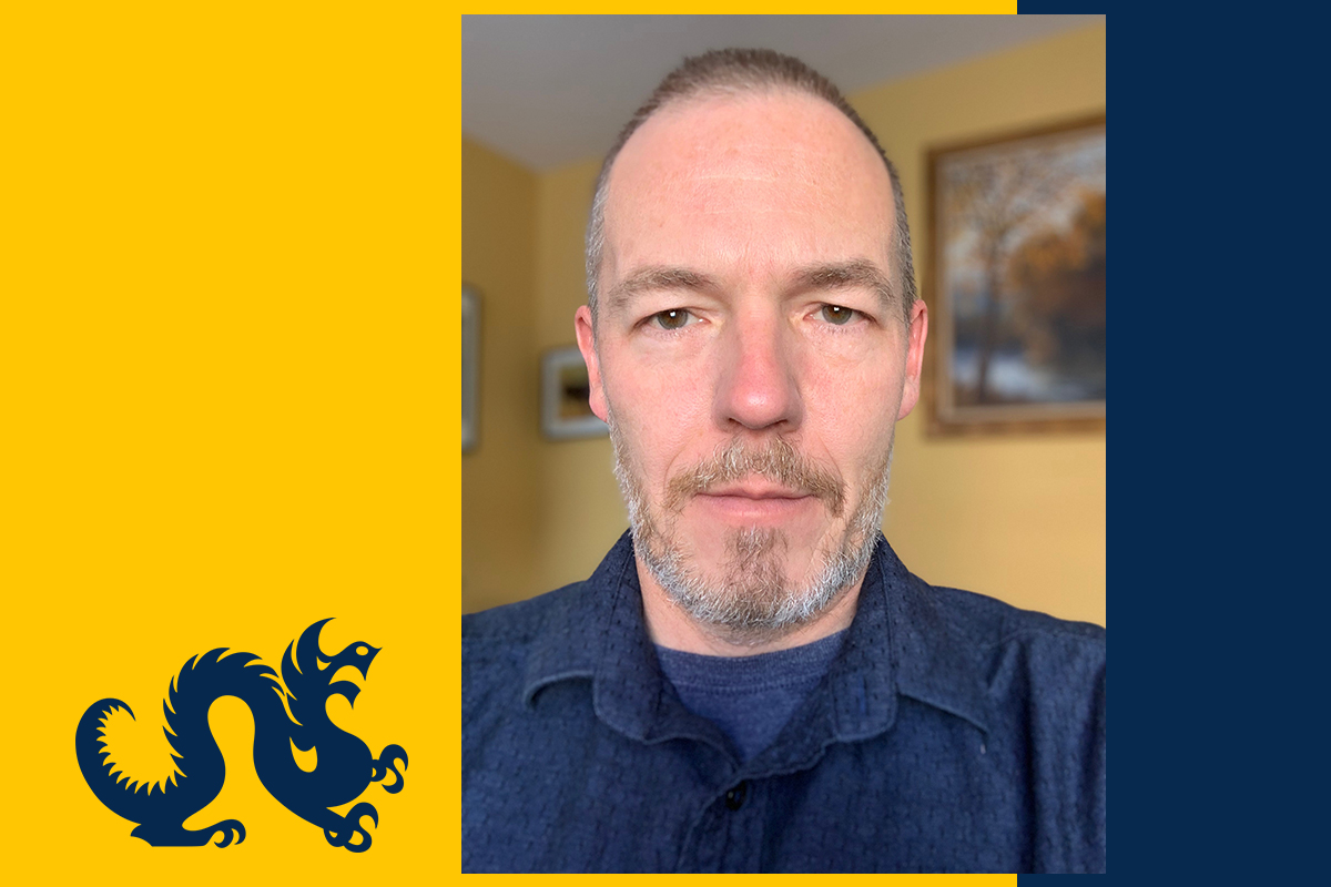 Photo of Christian Hunold on a blue and gold Drexel background