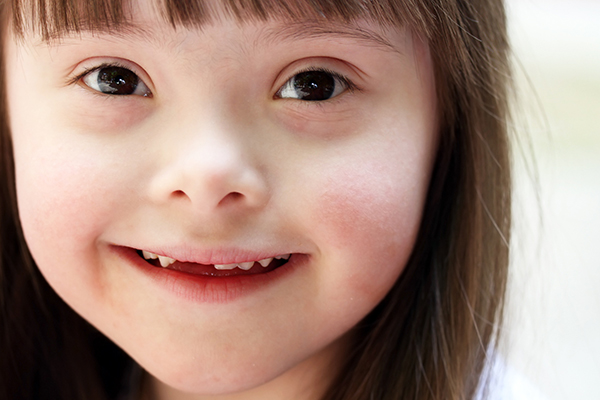 Young, smiling girl with Down Syndrome – Drexel University LADDER Lab
