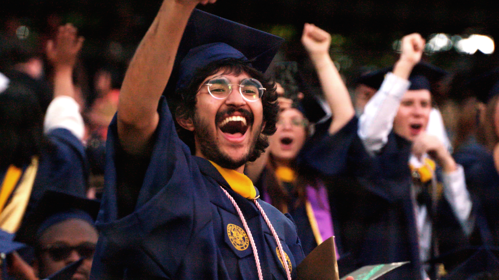 student celebrating at graduation