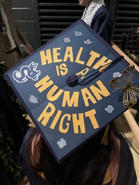 Dornsife graduation cap that says Health is a Human Right