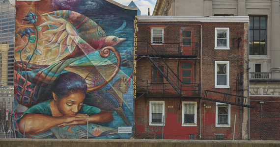 Philadelphia mural art depicting young woman reading a book that comes alive