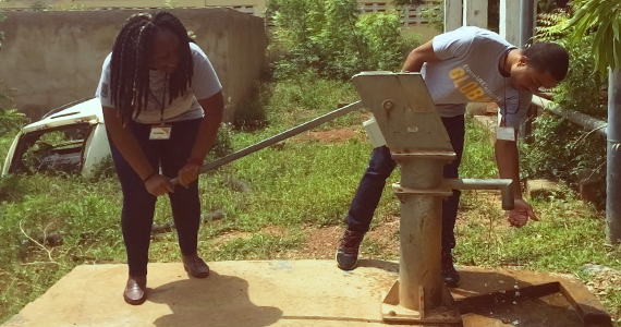 dornsife global students pumping water at a new well in Africa