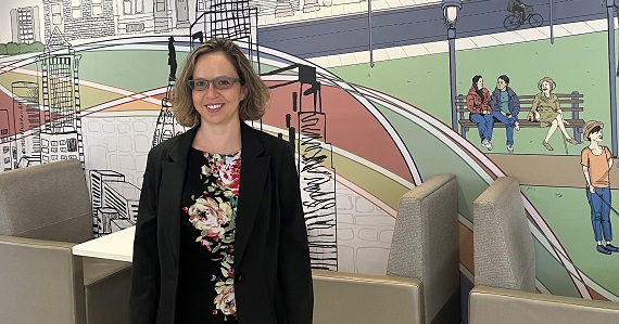 Dr. Lovasi in front of Dornsife's famed mural