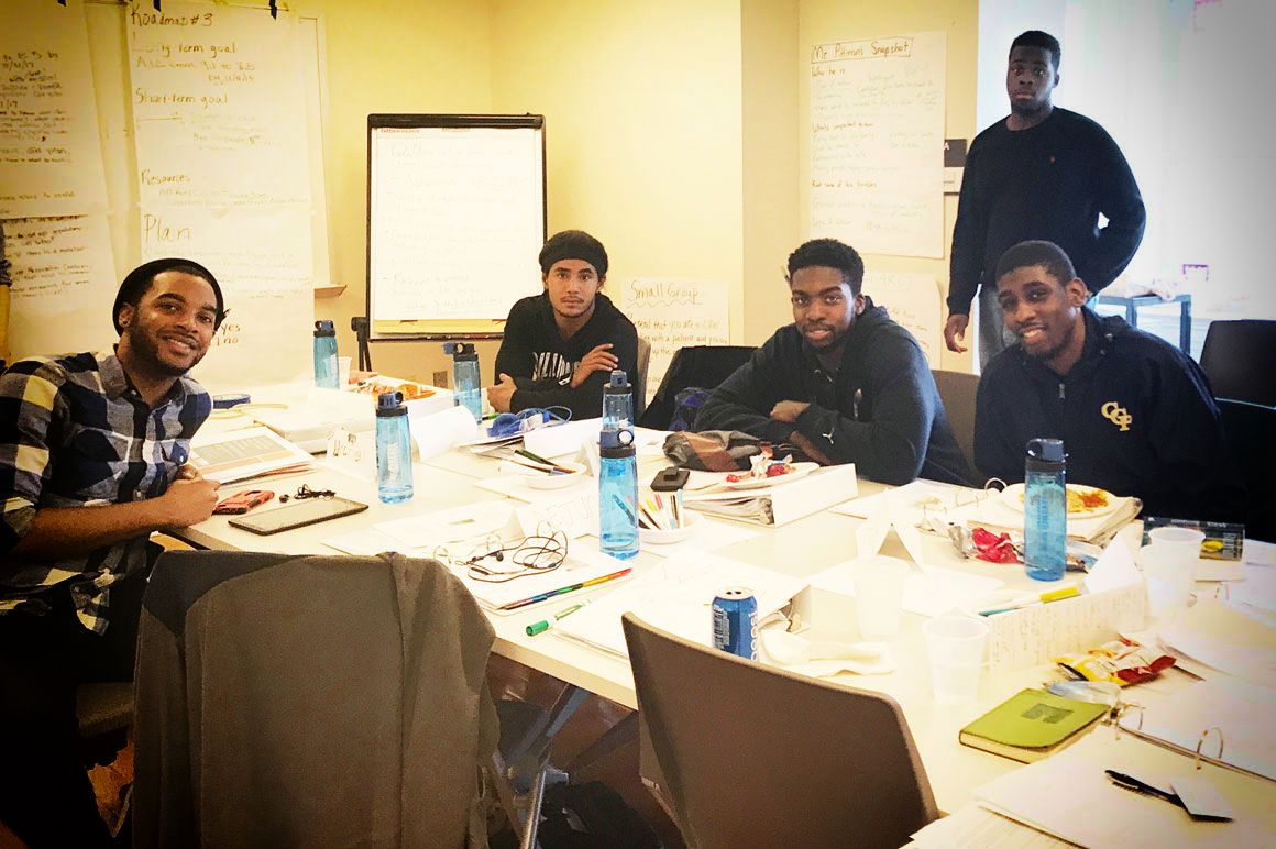 Group of young men around a table