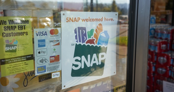 Sign in grocery store reads SNAP welcomed here
