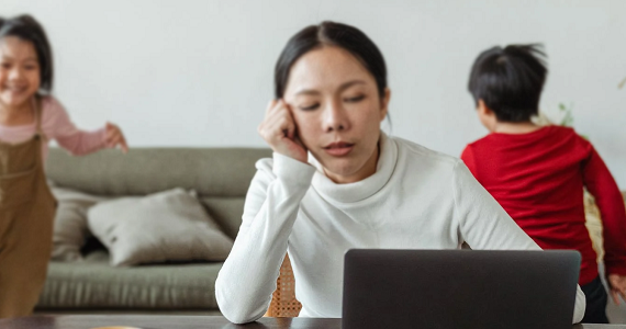 Women working from home and providing childcare