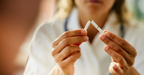 woman breaking apart cigarette