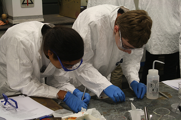 Students deposit a titanium dioxide paste on glass during creation of a dye-sensitized solar cell
