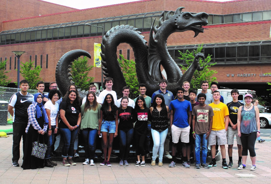 Students pose by Mario the Dragon at the end of the week