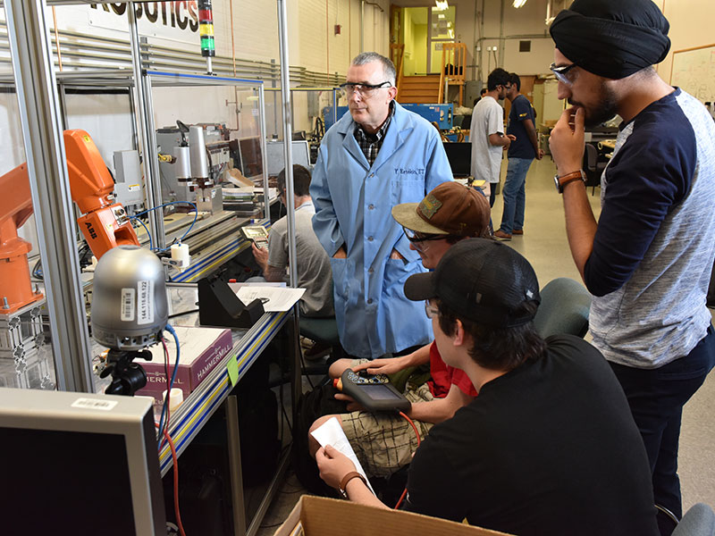Faculty member working with students in engineering lab