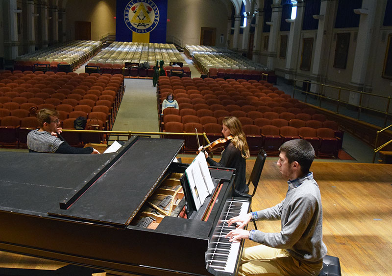 Students rehearsing in auditorium
