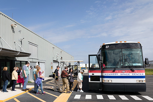 Guests board a bus for their tour of Kennedy Space Center.