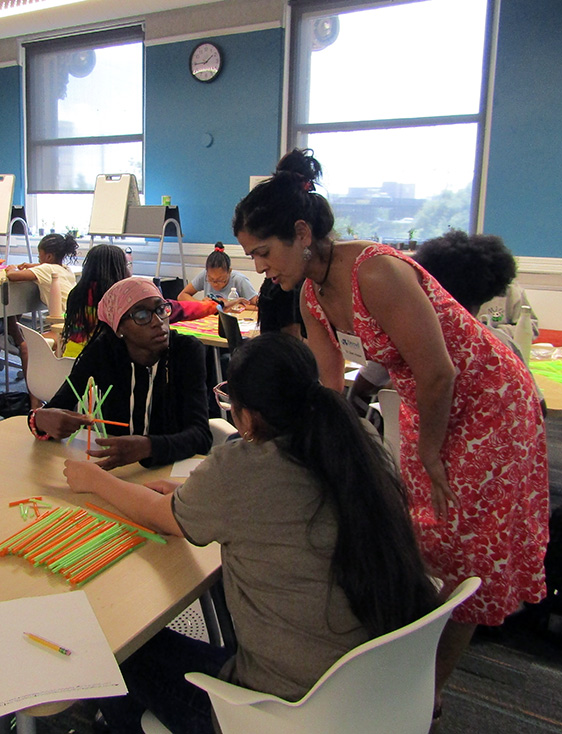 Dr. Simi Hoque works with students during the Eureka! STEM camp for girls