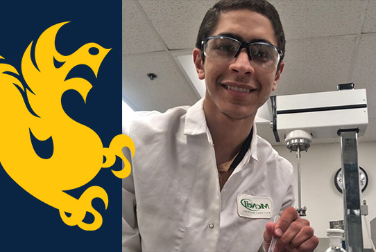 Student in lab coat working with lab equipment