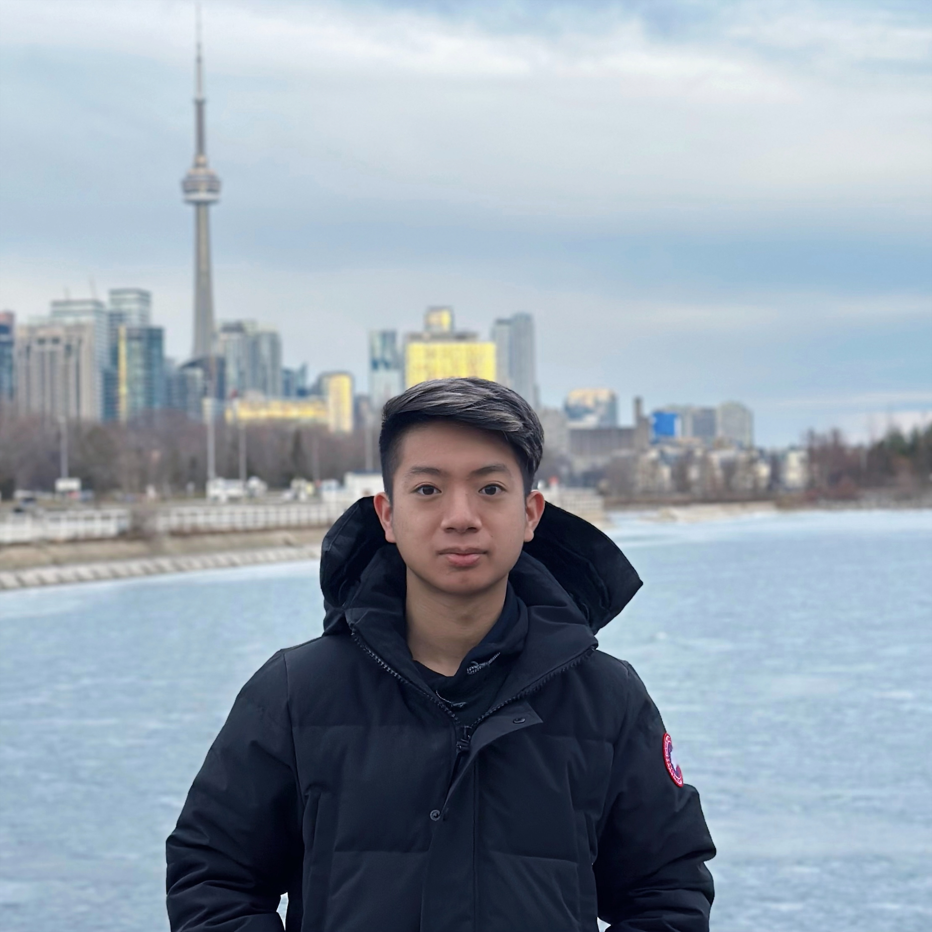 Luis stands in front of a sign that says "Essential AQUA"