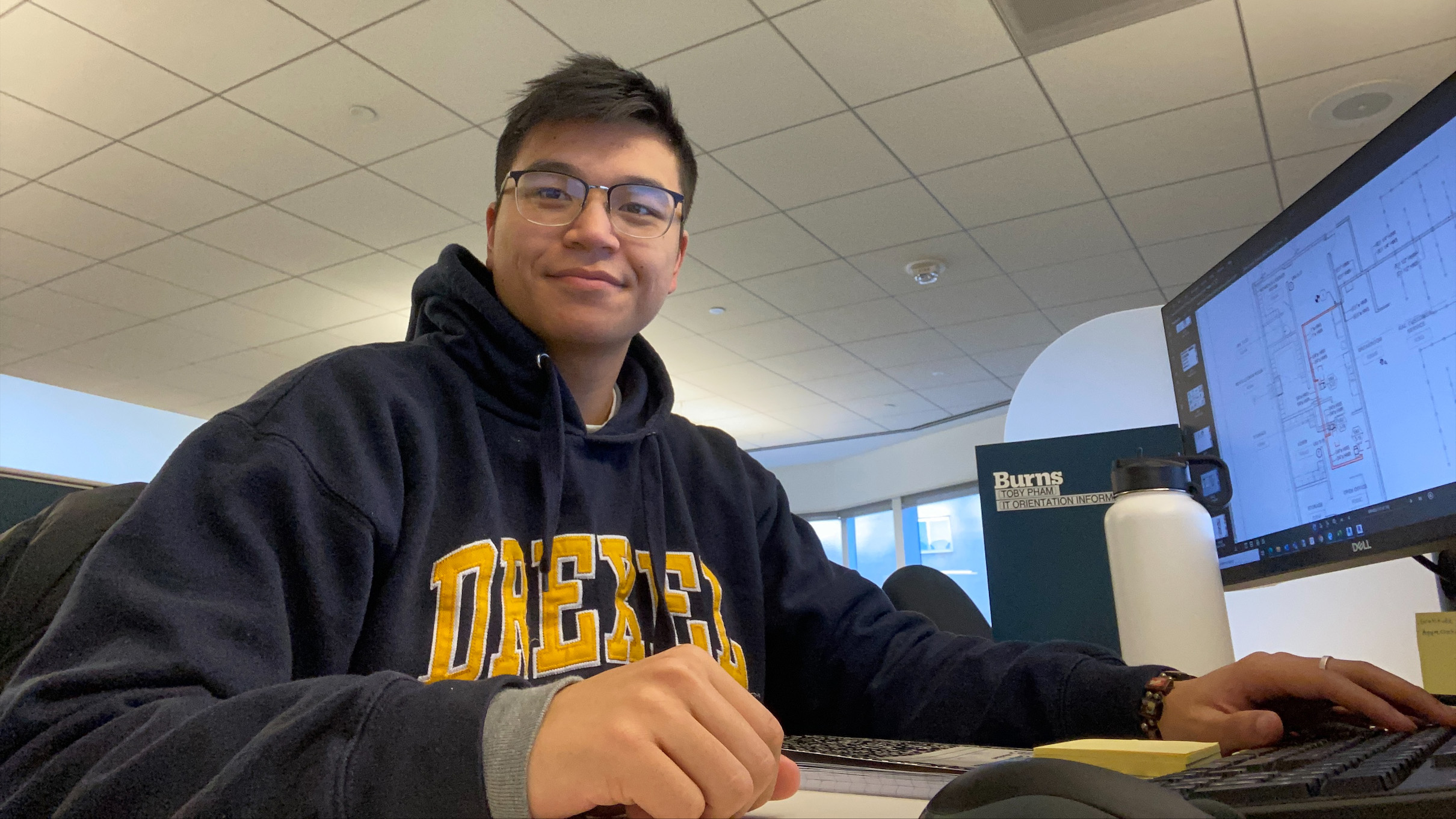 Toby Pham sitting at a computer.