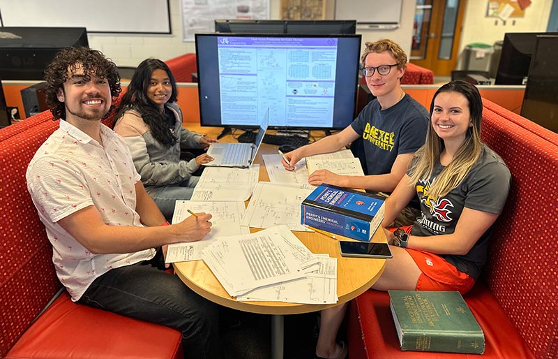 A group of Drexel CBE students sit at a table.