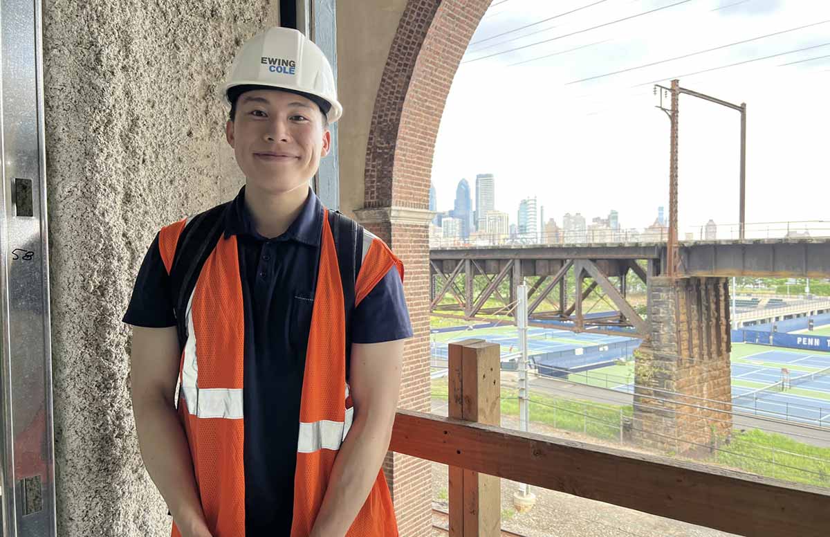 Ethan Yen stands in front of a constructed bridge