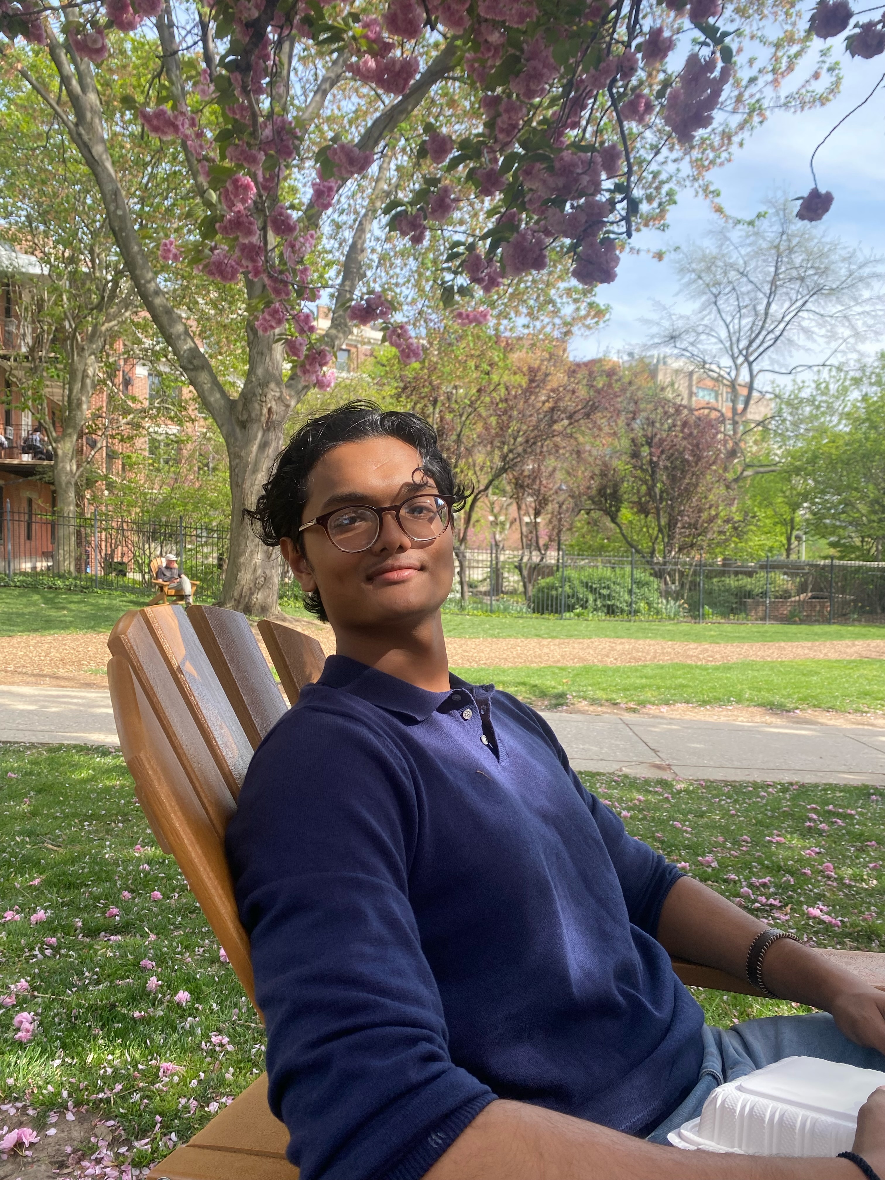 Mohd Apurbo sits in an Adirondak chair