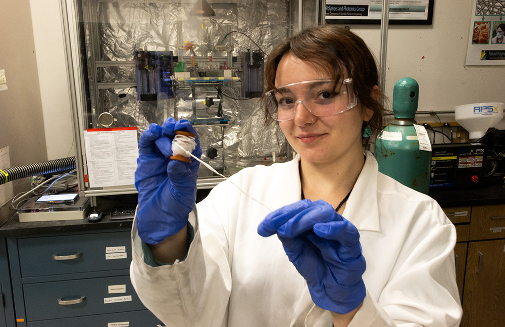 Saffron Buscemi holds a spool of nanoyarn