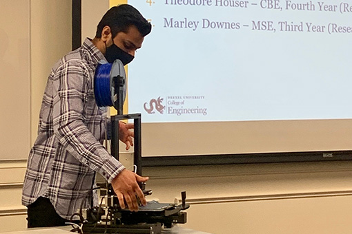 Dhruv Shah, a fourth-year mechanical engineering major, displays a 3-D printer during the Celebration of Undergraduate Research.