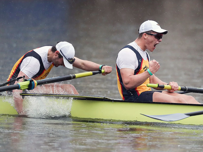 Two young men rowing in a a race