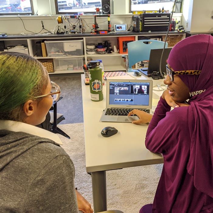people looking at laptop together