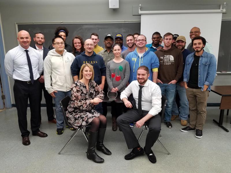 Students in classroom with advisors and faculty