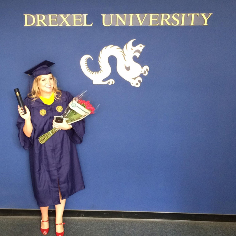 Amy Barley poses in front of a Drexel University banner.