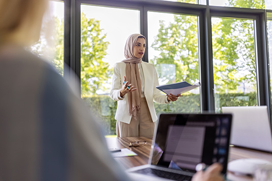 a woman presenting findings to stakeholders