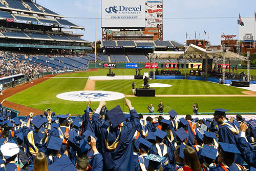 graduates celebrate in their regalia during drexel commencement