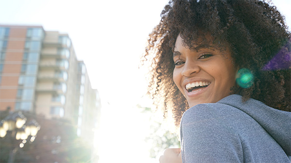 A Nonprofit Management student looks over her shoulder and smiles