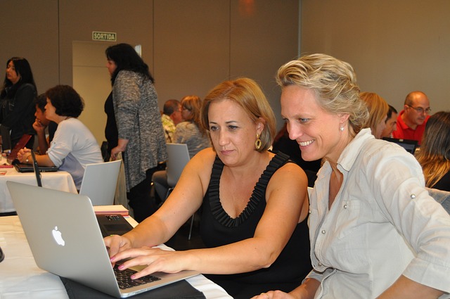 Image of two women at a computer, one is in her 40/50s and the other in her 60s