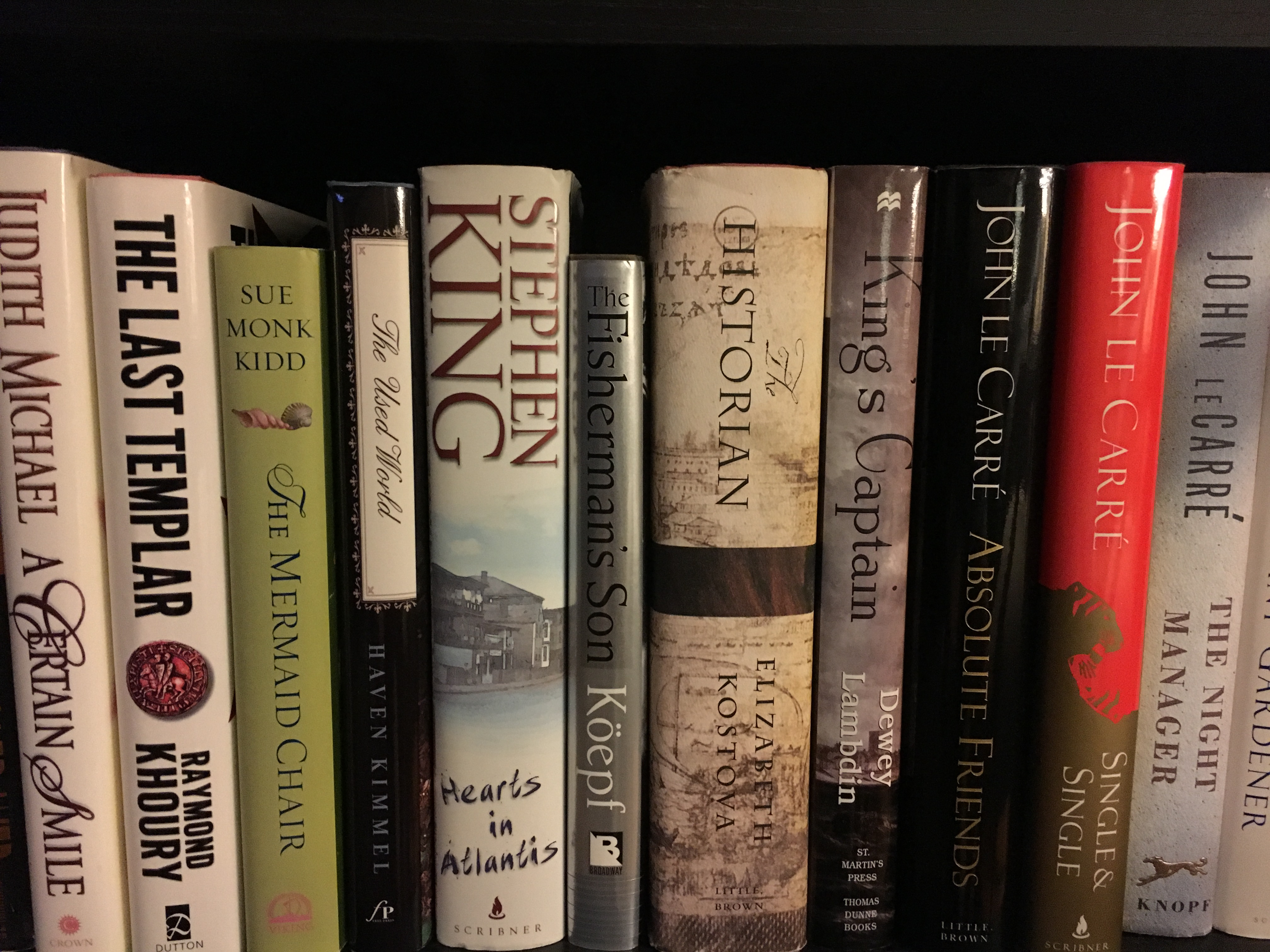 Image of 11 fiction books on a shelf