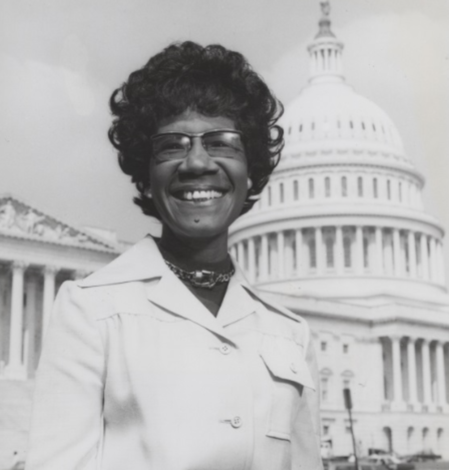 Image of Shirley Chisholm - first woman to run for President, standing in front of the US Capitol building