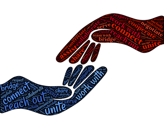 A red and blue word art image of hands, some of the words include unite, connect, reach out, and work with
