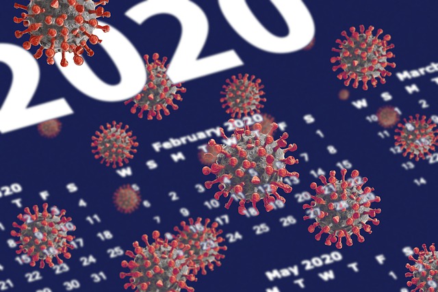 Image of a 2020 calendar with Coronavirus cells floating over it.