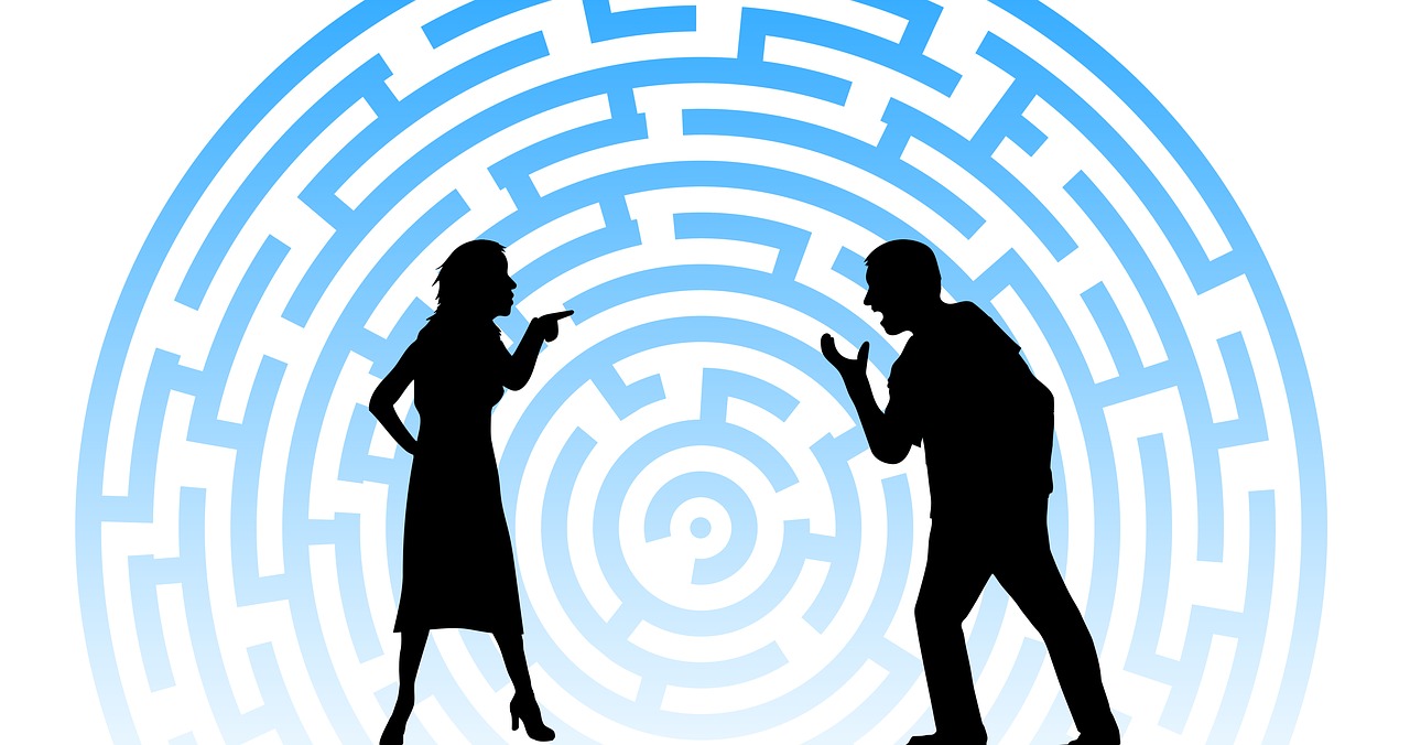 Image of silhouetted man and woman in front of a maze having an argument