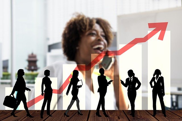 Image of a black woman in the background with a chart in front of her with silhouetted women depicting a increasing number, i.e. of women succeeding in the workplace.