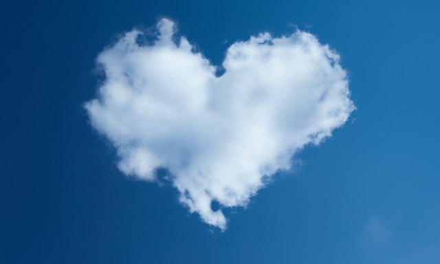 Image of a blue sky with a heart-shaped puffy cloud in the center.