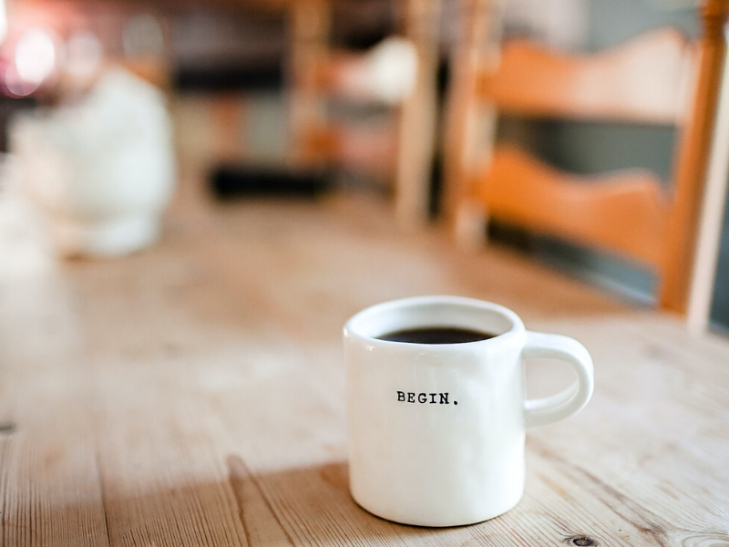coffee cup with the word begin on it