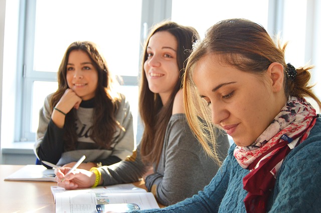 Image of three women at a meeting.