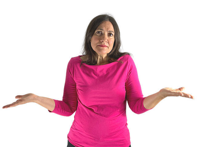 Image of a middle-aged woman with long brown hair shrugging as if not sure what to do.