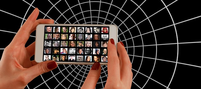 Image of a circular grid with a woman's hands holding a smart phone with a grid of faces on it.
