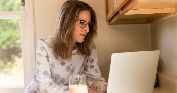 woman with glasses working from home with a laptop