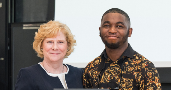 Anne Converse Willkomm and Essien Oku Essien posing with award