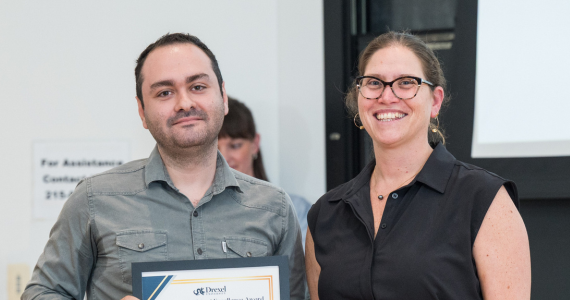 Student awardee posting with staff member
