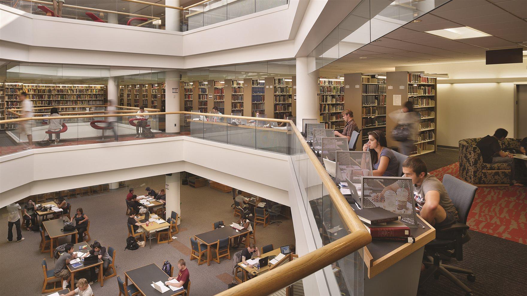 interior of Haggarty Library with students studying at tables, bookshelves